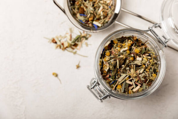 Herbal tea in a glass jar on a light gray background.top view.place for copy.